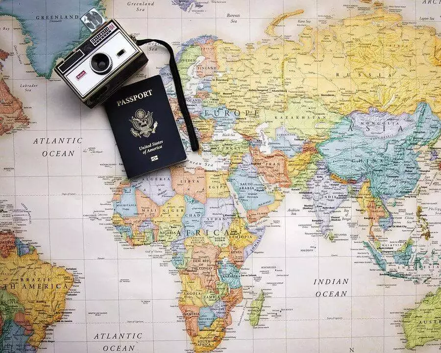 Passport and camera on a world map
