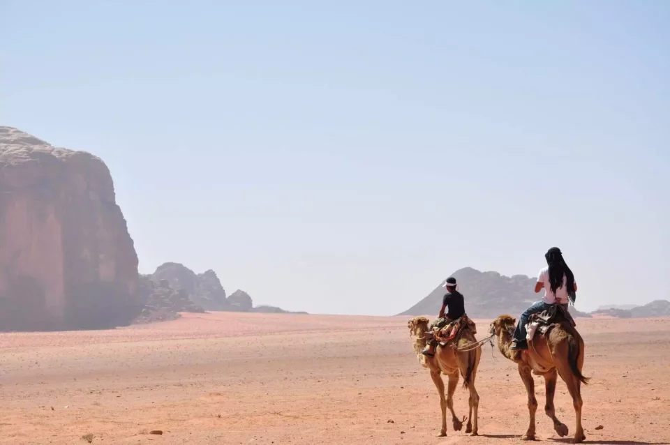 People on camels in Wadi Rum