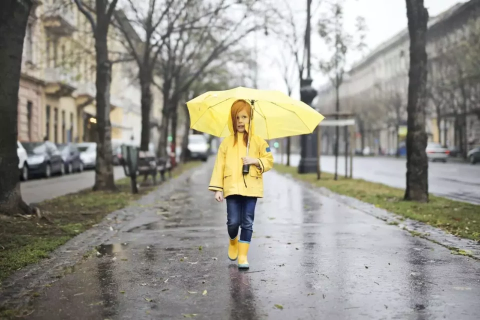 A child walking in the rain after moving abroad