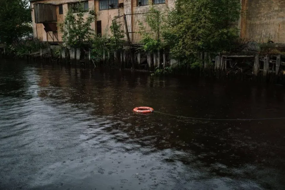 Red lifebuoy in the river after floods