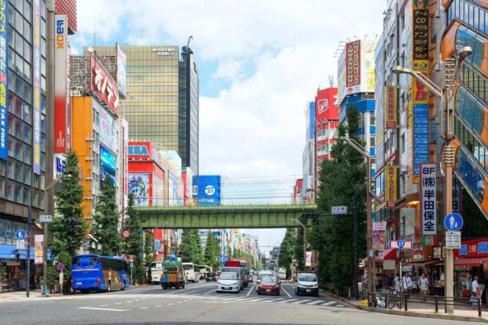 a street view of the colorful buildings and traffic in Akihabara, Tokyo