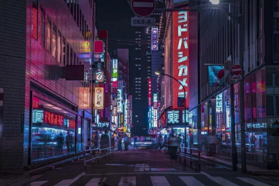 neon signs lighting up a street in Tokyo, Japan