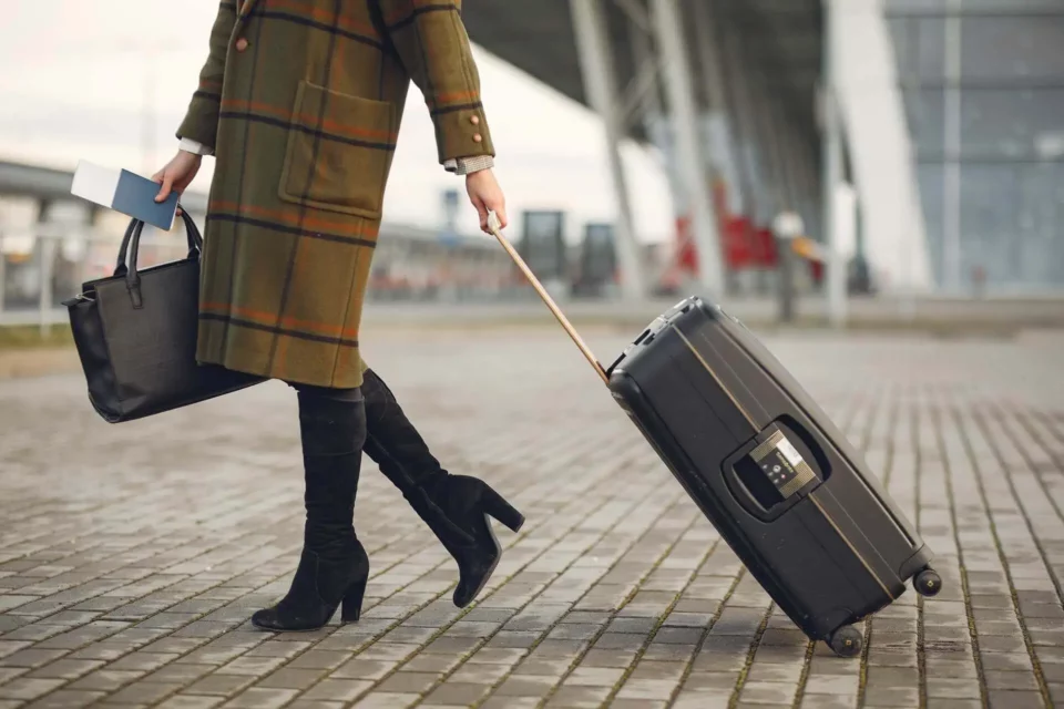 A woman with a suitcase moving internationally