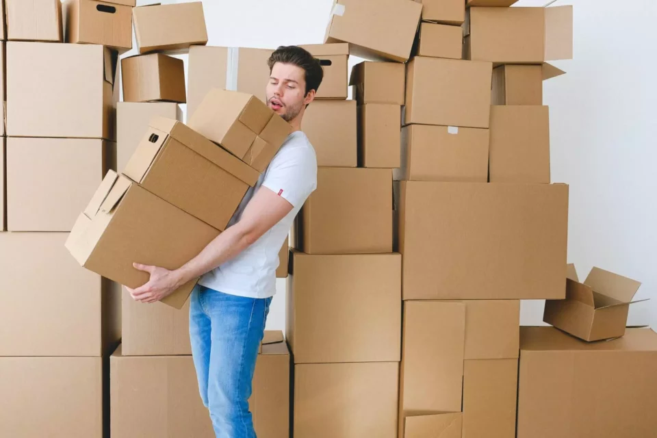 A man holding boxes before international moving