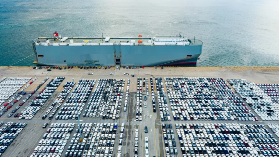 Freighter in harbor, loading cars for overseas shipping