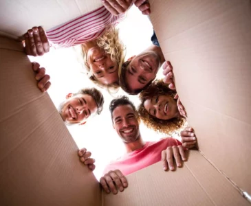 five people looking in a box