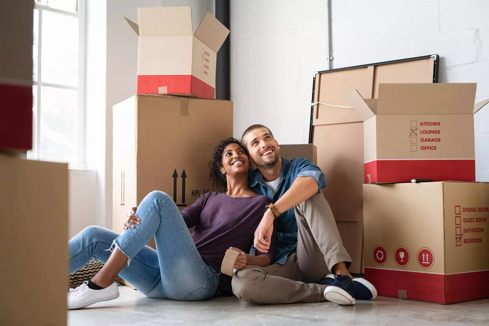 a couple smiling with boxes