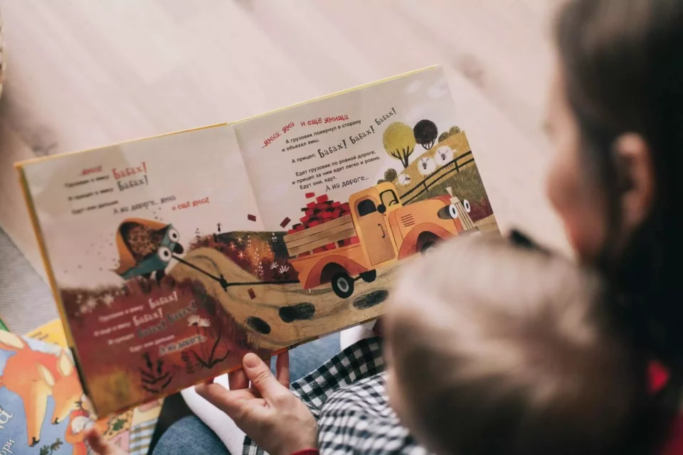 A babysitter reading to kids in a foreign language