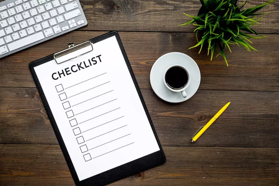 A woman making a checklist before an overseas moving company arrives