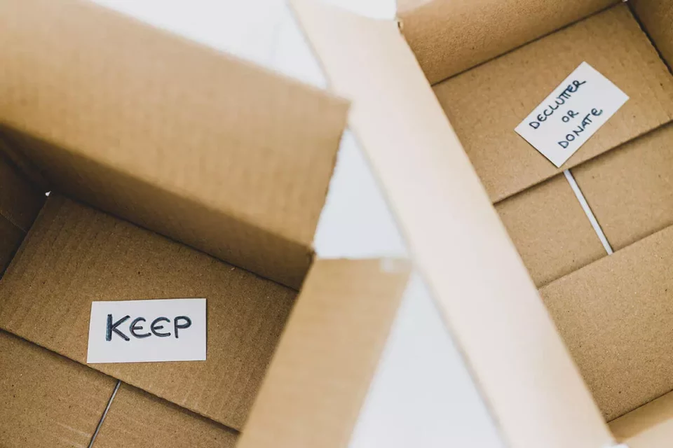 Two boxes that are labeled as keep and declutter or throw away