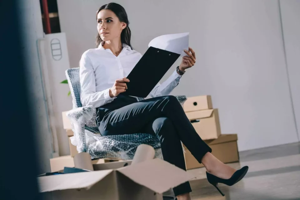 A woman in a working office getting ready for moving abroad
