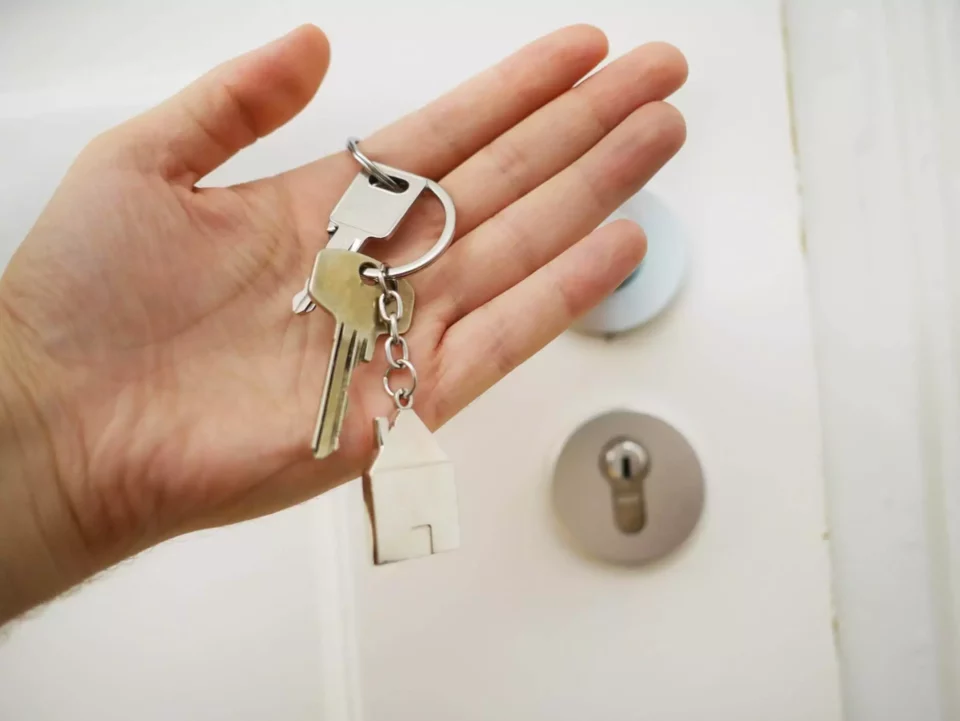 A person holding keys from a new house