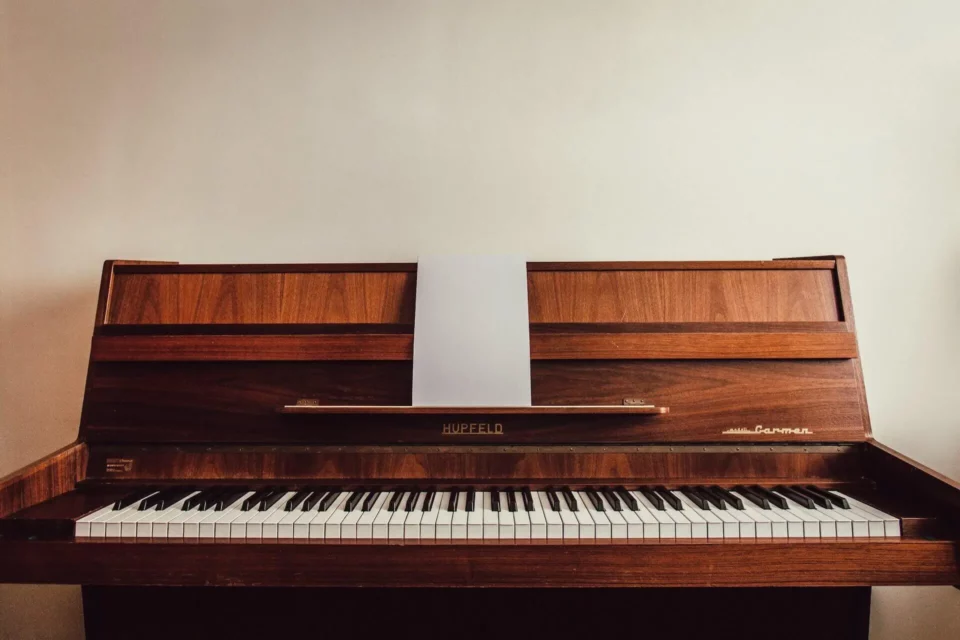 A picture of a brown upright piano