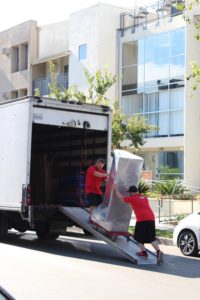 movers loading big boxes in the truck