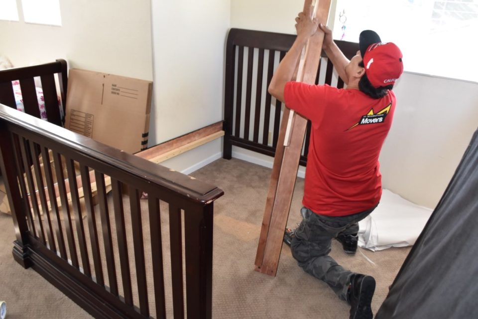A mover disassembling a bed