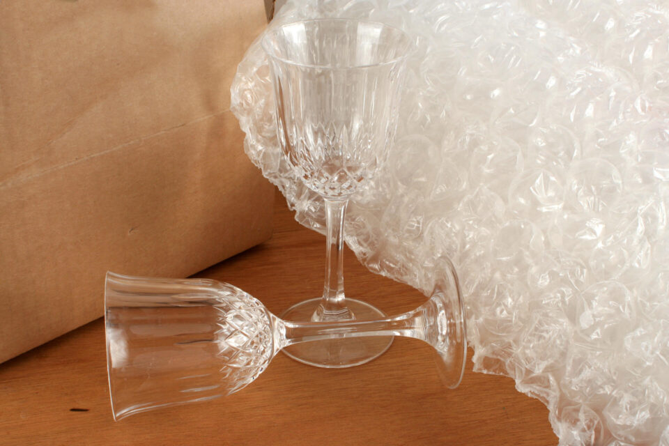 Packing crystal glasses with protective bubble wrap and cardboard box