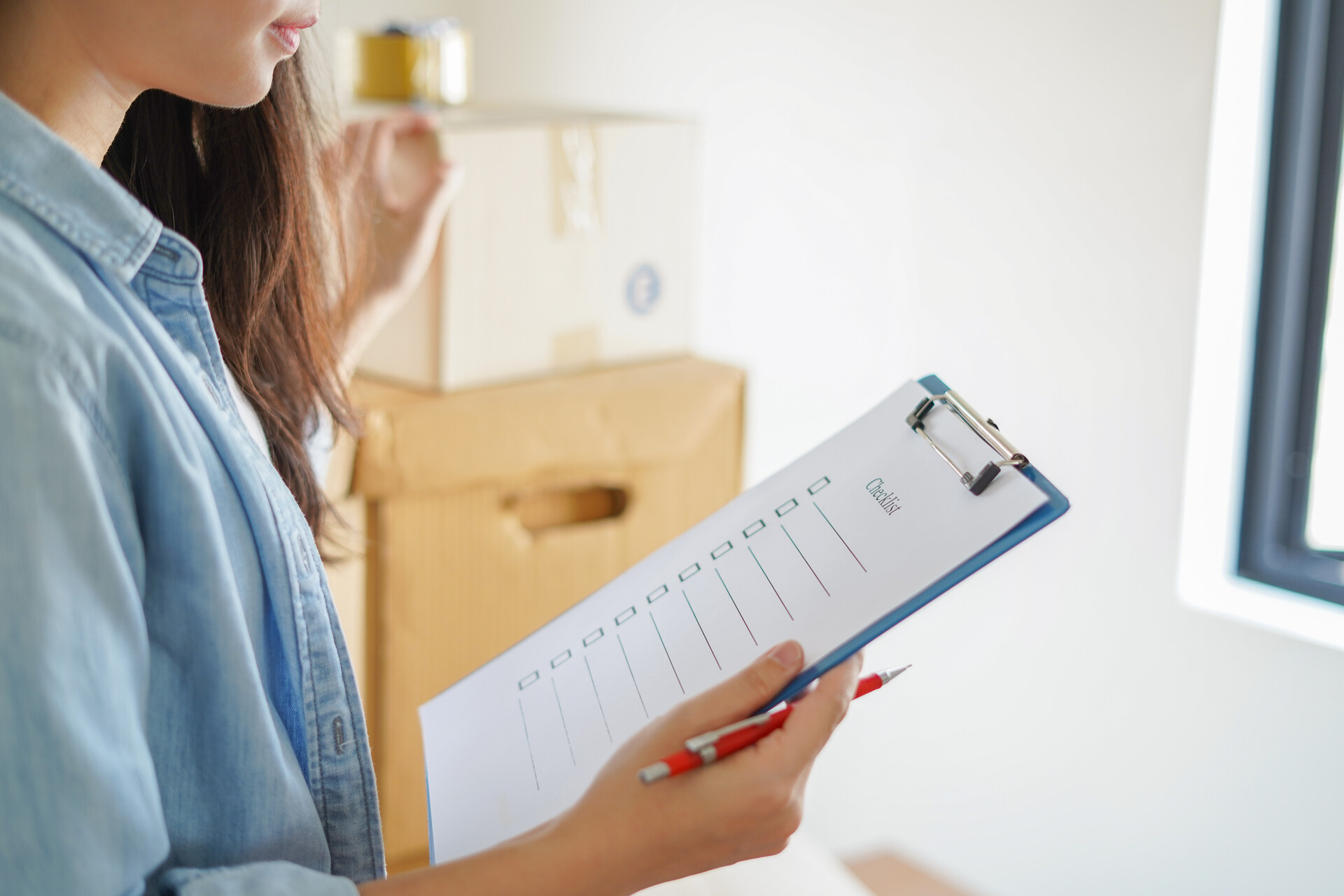 woman holding moving checklist