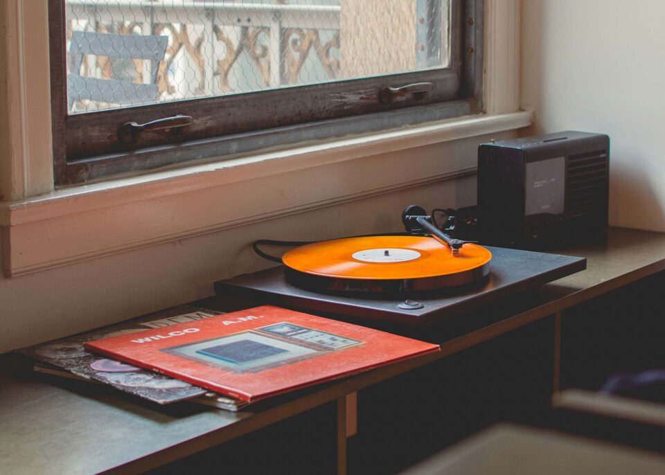A record player with records in the room