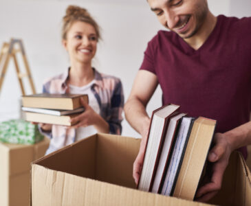 A man and woman packing books