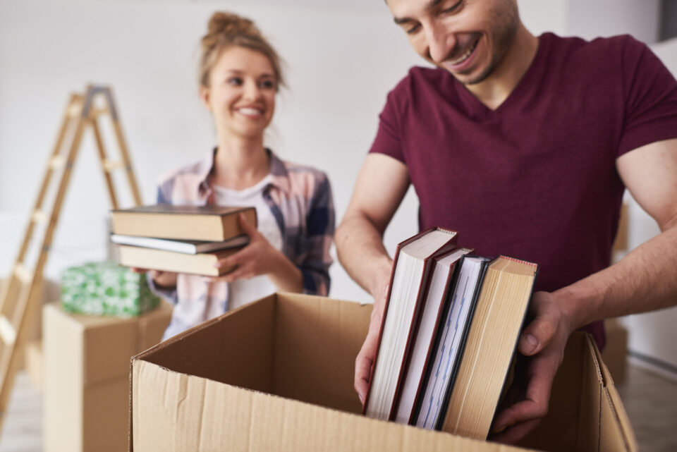 A man and woman packing books