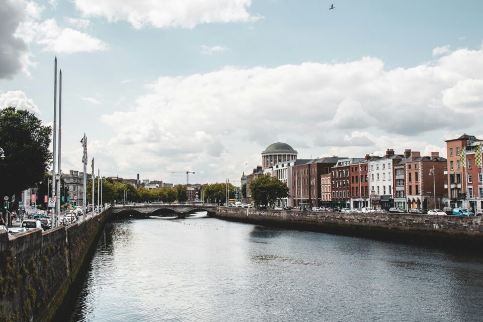 Scenic view of historic buildings lining a body of water with vibrant reflections, in Dublin.